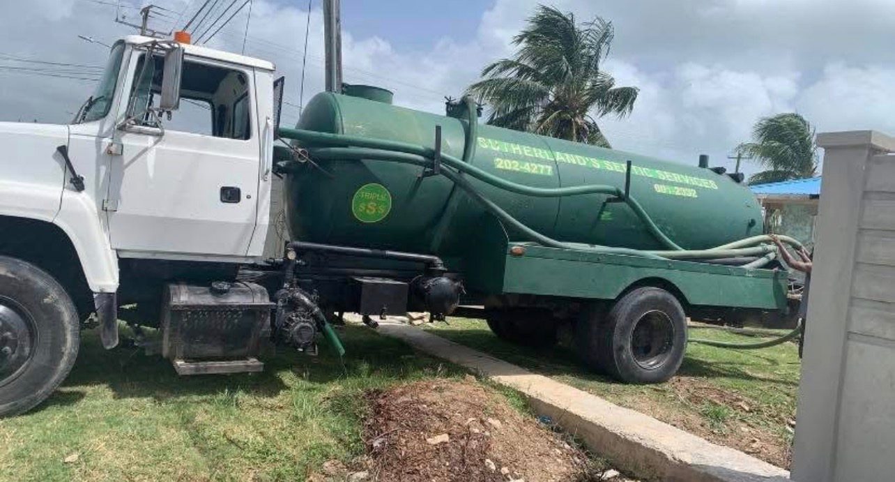 Sutherland Septic green tank truck working on site