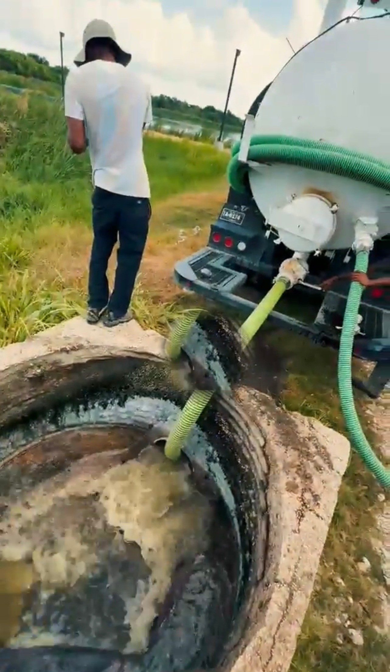Hoses pumping out a septic tank in Belize