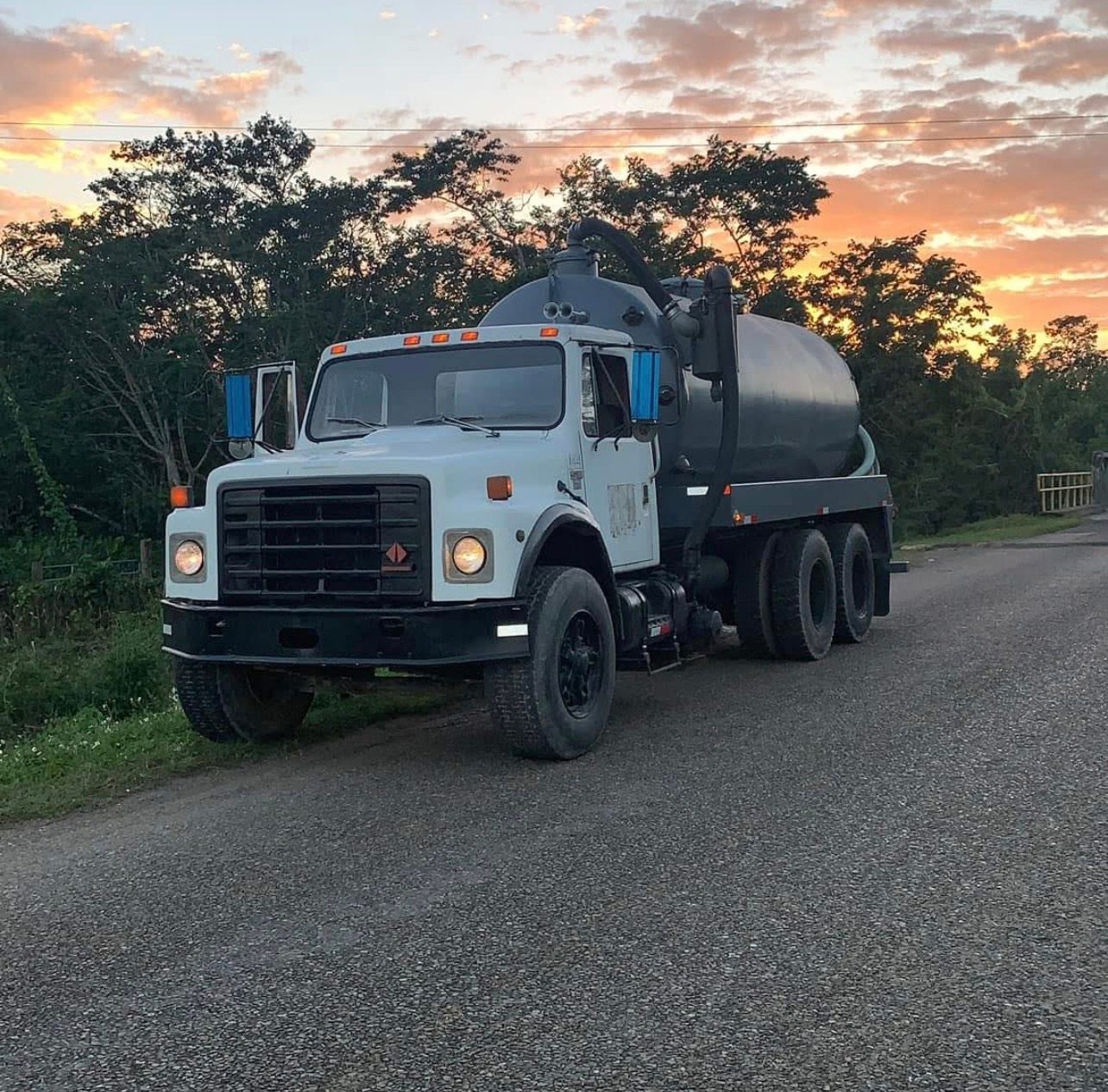 Sutherland Septic vacuum truck on the road at sunset